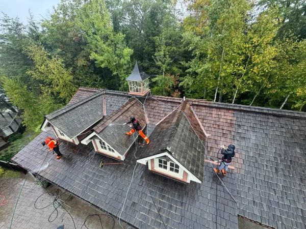Brite team pressure washing a roof in Ontario